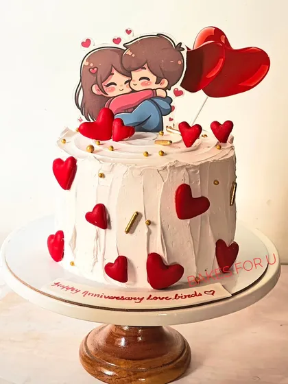 A sweet anniversary cake for the love birds, topped with a cute cartoon couple and surrounded by red hearts. A simple and charming way to say "I love you."