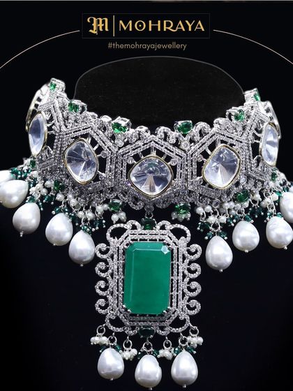 A close-up of the stunning emerald and polki choker, highlighting the intricate design and the quality of the stones.