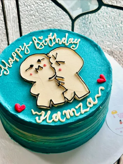 A custom cake with a cute and quirky illustration of a couple kissing. The ombre blue-green background adds a beautiful, artistic touch to this birthday cake.