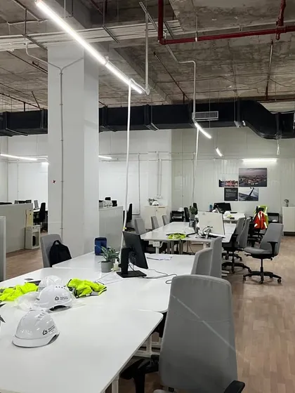 This is an actual photograph from a completed turnkey project for a major corporate client. It shows a functional open-plan office environment we delivered, demonstrating our capability to execute large-scale interior fit-outs from concept to completion.