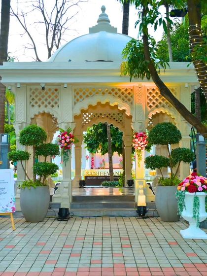 The entrance to the reception venue was marked by this beautiful white gazebo, decorated with floral arrangements, setting a romantic and stately tone for the evening.