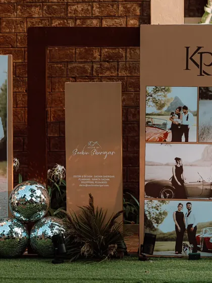 A creative and personal welcome area for a Sangeet. This setup included a collage of the couple's photos, disco balls, and a custom sign, instantly setting a fun and personalized tone.