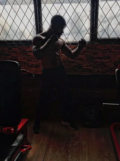 Shadow boxing in the gym, staying agile and athletic.