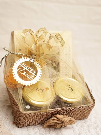 Our Assorted Delight Hamper, wrapped in delicate netting for a beautiful presentation. This gift includes jars of our healthy treats and a box of handmade sweets.