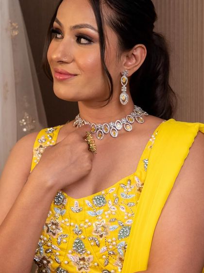 Brighten up any event with this vibrant yellow embroidered blouse and sharara set. It's a cheerful and stylish choice for a Haldi ceremony or spring wedding.