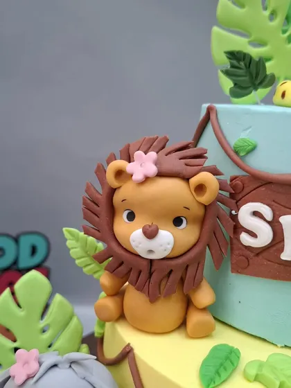 The lion topper with a cute pink flower.