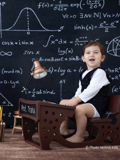 Meet Professor Trisha. Our 'little professor' theme is a fun and quirky way to capture your child's curious personality, complete with a chalkboard of equations and a tiny desk.