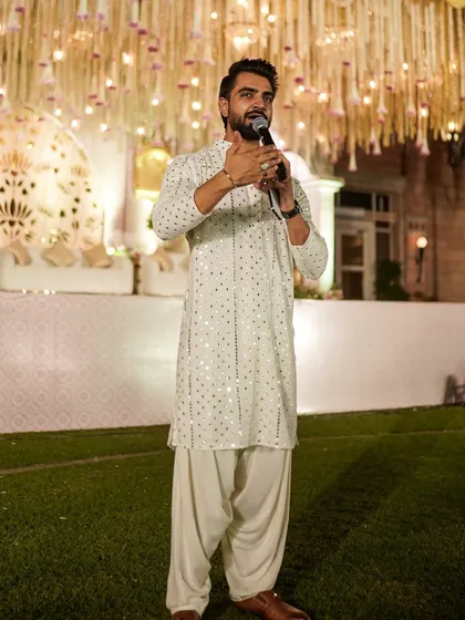Dressed in a classic white kurta, ready to host a beautiful wedding ceremony. My style adapts to the event, bringing elegance and poise to the formal parts of your celebration.
