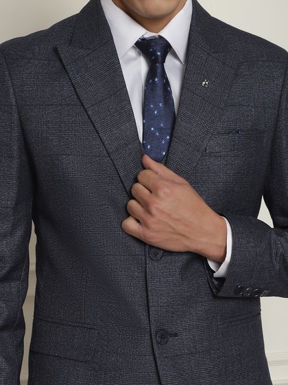 A close-up of a classic navy blue textured three-piece suit. Perfect for formal office wear or any daytime formal event.