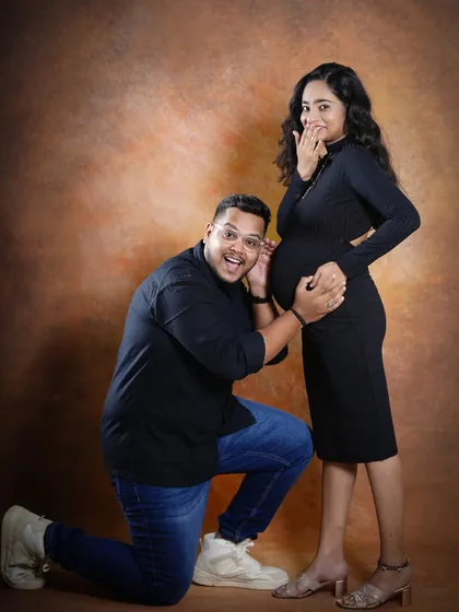 We encourage playful and candid moments during our couple sessions. Here, the father-to-be joyfully listens to the baby bump, creating a fun and heartwarming memory that truly reflects their personalities.