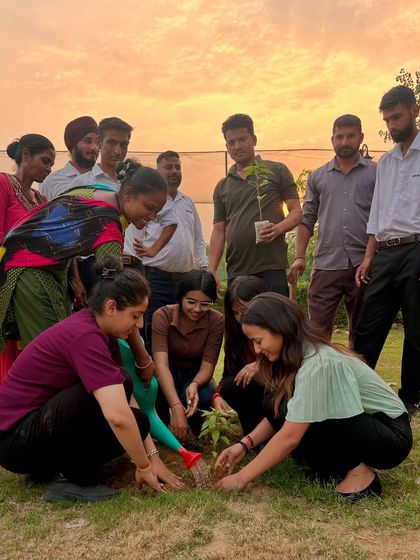 Everyone gets involved in our green initiatives. This photo captures the joy and teamwork of planting a sapling together during our World Environment Day event, set against the warm glow of sunset.