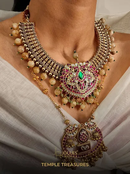 Layer your treasures. This temple-inspired layered necklace set features a heart-shaped pendant and divine motifs, allowing every strand to tell a story of heritage.