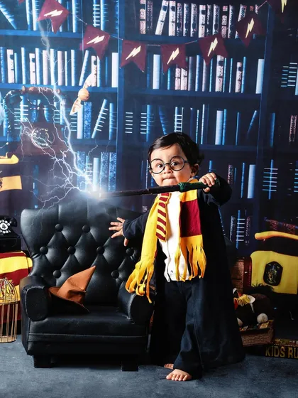 Wingardium Leviosa! For all the Potterheads, I offer a magical Harry Potter themed photoshoot. With a library backdrop, a Gryffindor scarf, and a magic wand, your little one can step right into the wizarding world.