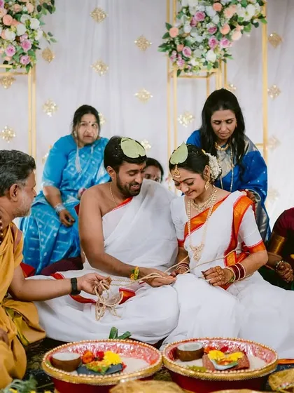 The priest guides the couple through the intricate rituals of their Telugu wedding ceremony.