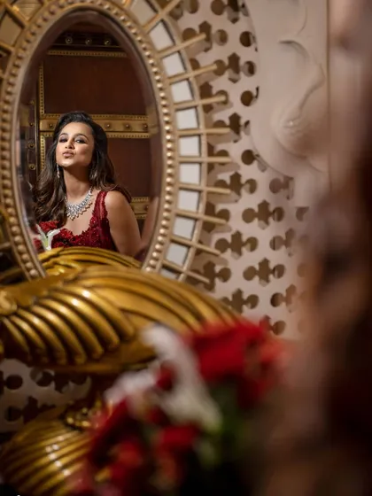 A creative bridal portrait using a mirror to capture a reflection. This adds depth and an artistic touch to the image.