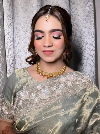 A detailed look at the eye makeup for this elegant party style. The blended pink and brown tones create a sophisticated look that is both modern and timeless.
