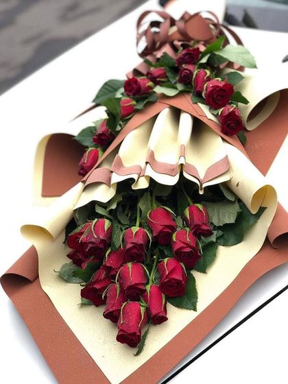 A custom-designed cascading bouquet of red roses. If you have a specific design in mind, just send me a photo and I can create it for you.