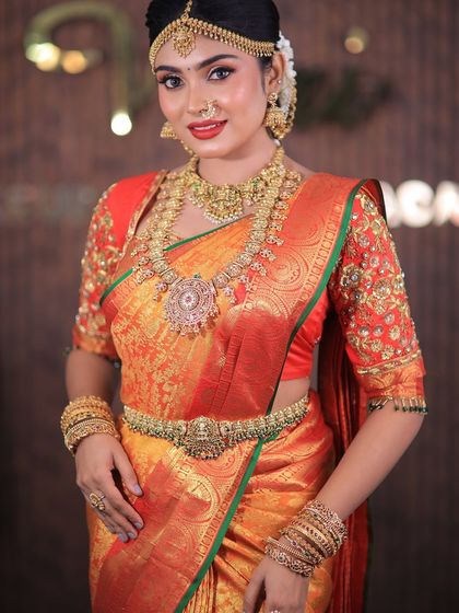 More shots of this gorgeous red and orange Kanchipuram saree. For photoshoots, I ensure every detail, from the pallu to the waist pleats, is absolutely perfect.