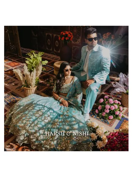 A cool, sun-kissed portrait of the couple at their Haldi carnival. The starburst lens flare adds a touch of magic to this stylish and relaxed shot.