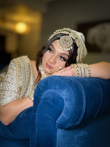 Another shot of the bride in the white lehenga, showcasing her beautiful makeup and the intricate details of her outfit.