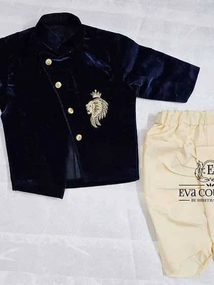 Another view of the newborn-sized navy blue velvet jacket and dhoti set.