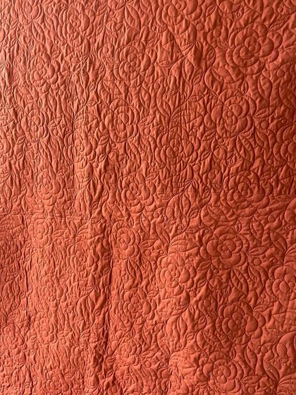 The reverse side of the saree quilt, showing how our detailed stitching creates a beautiful pattern on the solid-colored fabric.