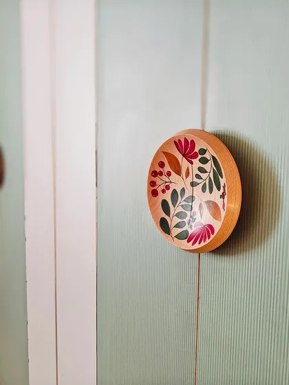 The smallest details tell the biggest stories. These custom wardrobe handles were hand-painted by artisans, turning a functional element into a unique piece of art that adds a personal, floral touch to the bedroom.