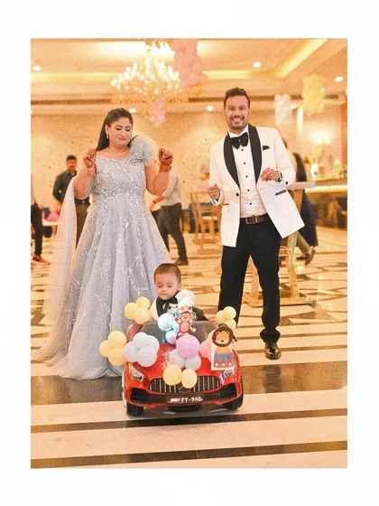 Capturing the grand entrance at a first birthday party. I focus on candid event photography to document the real fun and excitement of your celebration, like this little one arriving in his own balloon filled car.