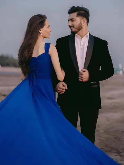 A look of love. This beach pre-wedding photo captures a beautiful moment between the couple, with the bride in a striking royal blue gown.