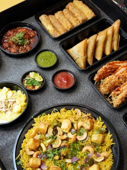 A full view of our Iftaar Box contents, including Amroha Pulao, Chat Aloo, Pav Halwa, and various fried starters.