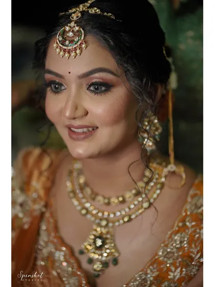 A close-up of the bride's happy face, showing her beautiful smile and radiant makeup.