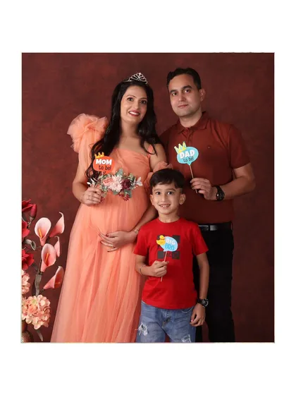 A complete family portrait. The older brother joins his parents, creating a beautiful image of a family of three about to become four.