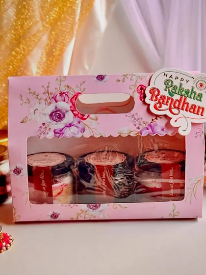 Our assorted cake jars are a huge hit for Rakshabandhan. This gift pack includes three of our most popular flavors, like Red Velvet and Belgian Truffle, presented in a festive floral window box.