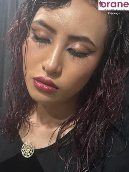 A close-up of the eye makeup, featuring a sharp winged liner and shimmering, glossy lids.