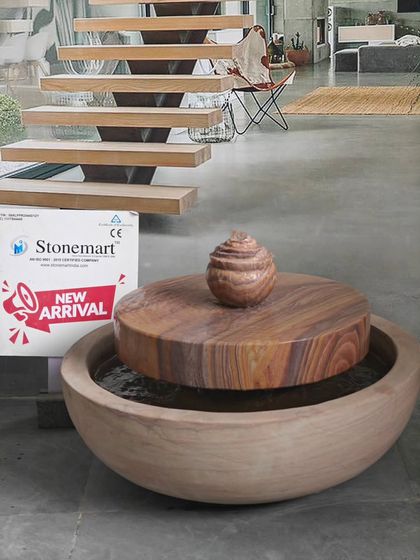 This modern fountain features a millstone design, with water bubbling up from the center and flowing over the sides into a large bowl. It can also serve as a lily or fish pond.