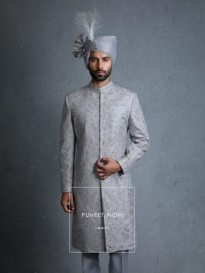 Inspired by Mughal grandeur, this powder blue sherwani is embroidered with intricate zari, handwoven florals, and sequins. Every detail speaks of heritage and artistry.