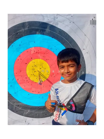 The smile says it all. This is the result of dedication and precision. We celebrate every bullseye and every improvement, helping our young archers build confidence with each arrow they shoot.