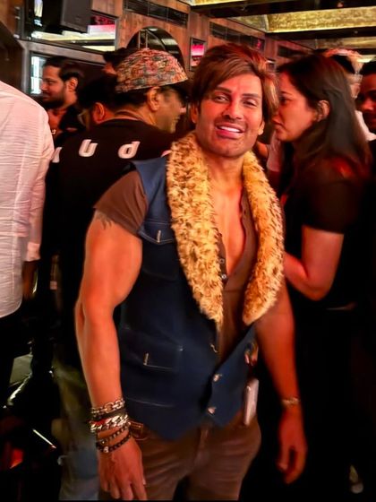 Our client Mr. Yash looking fabulous in a custom creation, featuring a denim vest with a fur collar for a bold and unique party look.