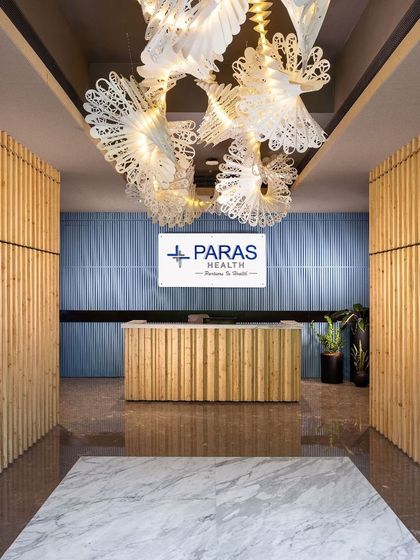 A close-up of the 'Spiral of Life' origami chandelier at the Paras Healthcare reception. This stunning interplay of art and light symbolizes well-being and interconnectedness, leaving a lasting impression on all who enter.