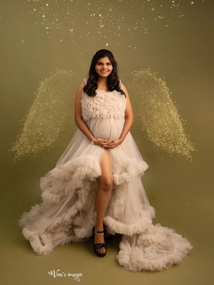 A touch of magic with golden, sparkling angel wings added to this beautiful portrait. The mother's joyful smile completes this enchanting image.