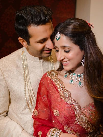An intimate moment during their wedding celebration. The soft lighting and close framing create a romantic and personal feel.
