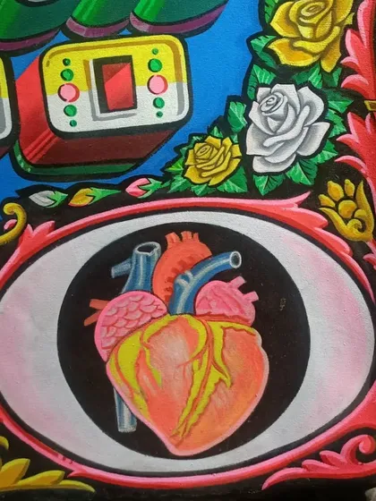 A detailed painting of an anatomical heart from the border of the Iron & Gold Tattoo sign.
