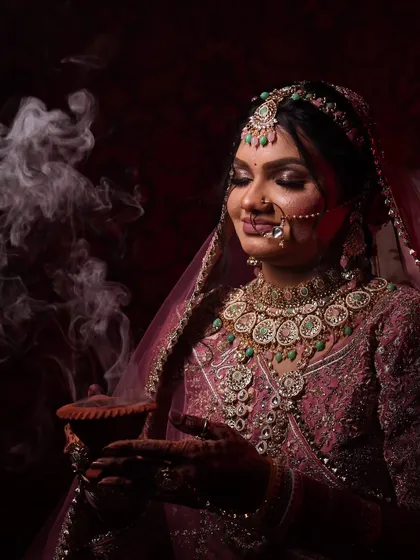 Another take on the diya shot, this time with a bride in a pink lehenga. The smoke adds a mystical element to this beautiful portrait.