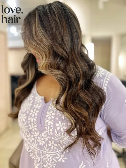A side view of this complex brunette balayage, showing off the money piece and dimensional color.