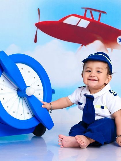 A happy little pilot, ready to fly. The smile on his face shows how much fun these imaginative, themed sessions can be.