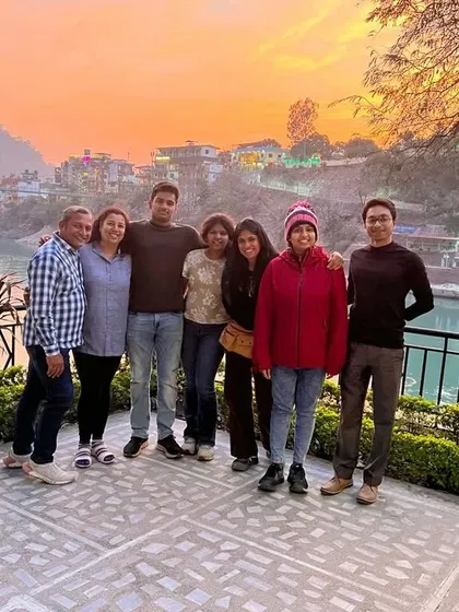 Cherishing the magical sunset by the river with my students during our spiritual journey in Rishikesh.