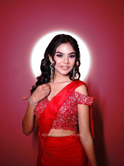 A smiling shot that shows just how fun and easy to wear this red drape saree is. Look glamorous without any of the fuss.