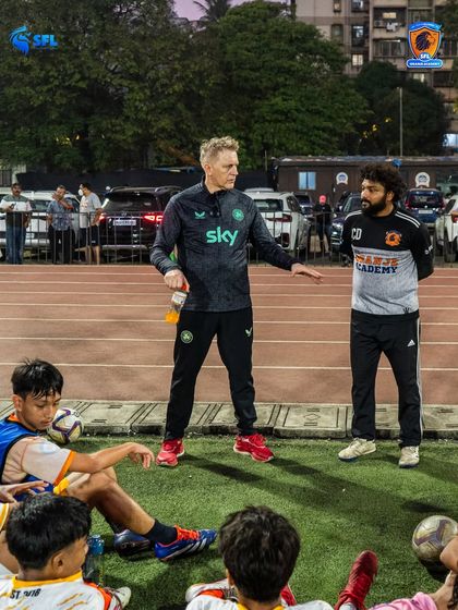 Heimir discusses strategy with our SFL Oranje coaches during a training session. This continuous dialogue ensures our coaching philosophy is applied consistently across all age groups.