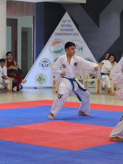 Our young athletes demonstrate a coordinated sequence of punches and stances, showcasing the teamwork required for group pattern events.