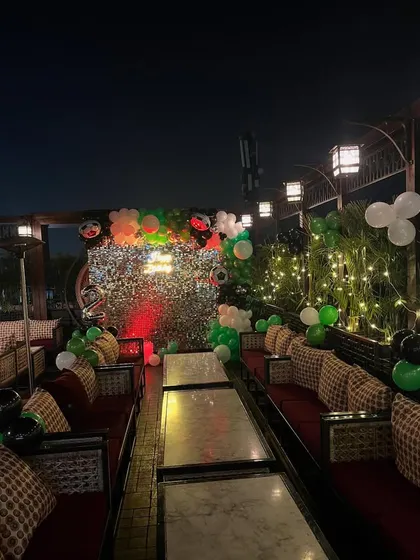 The full terrace area decorated with balloons and lighting for the birthday celebration.